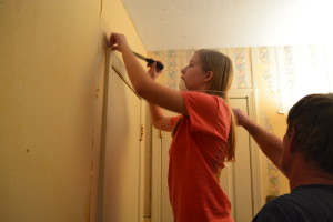 Bathroom Renovations with my daughter and husband removing old wallpaper.