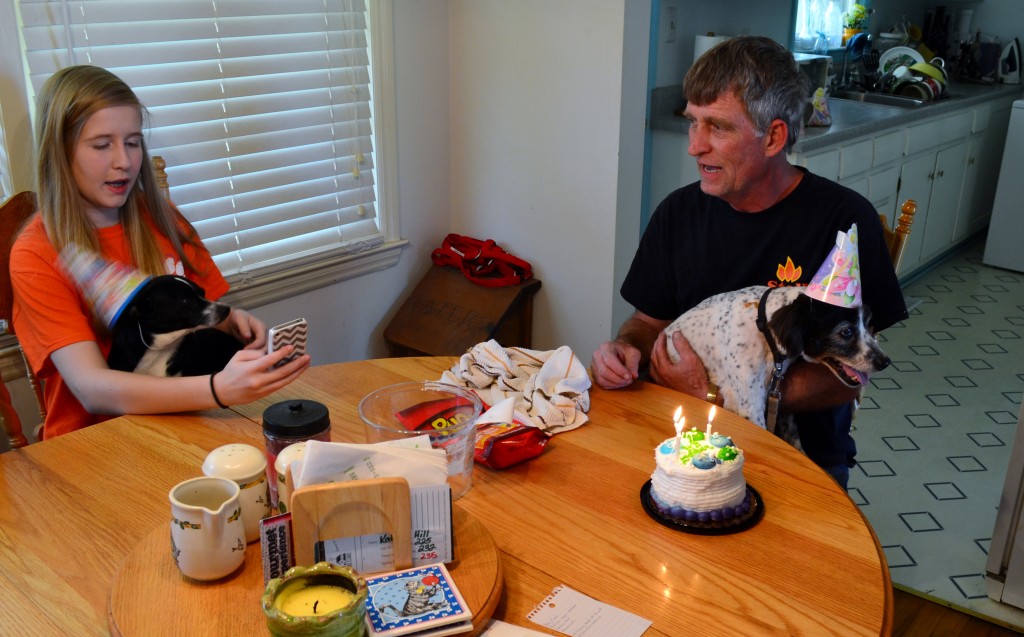 Singing Happy Birthday and my daughter takes a picture of her dog with her birthday hat.