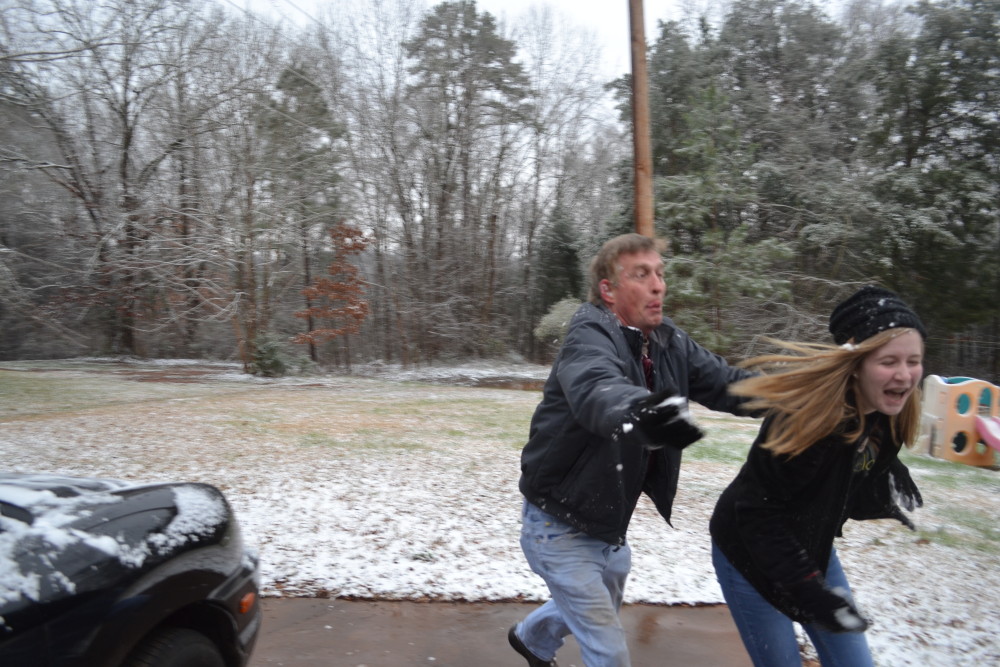 Simple times: My husband and daughter enjoy a snowball fight.